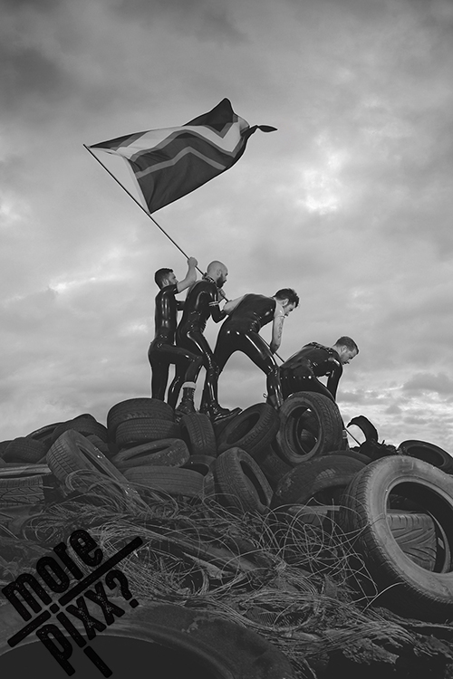 Sly Hands photograph: four men in rubber with a flag on a pile of tyres