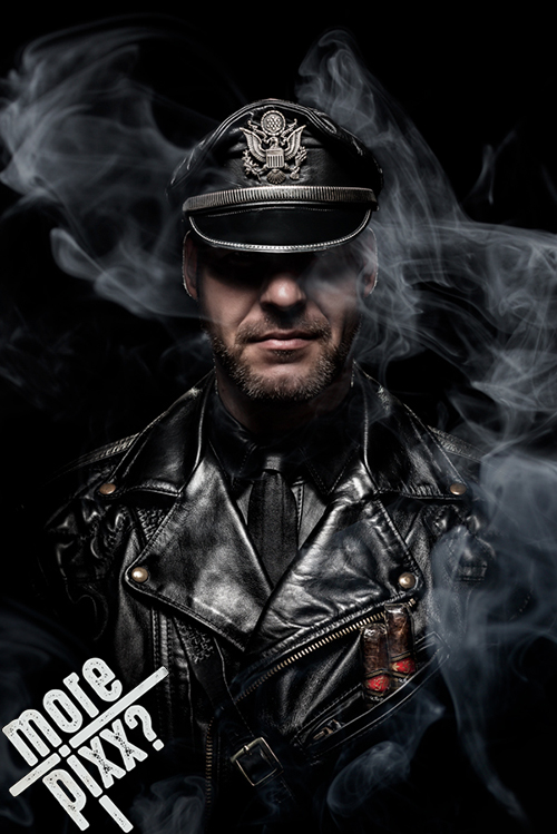 Portrait of a man in a leather jacket and cap surrounded by smoke — photograph by Max Samauth
